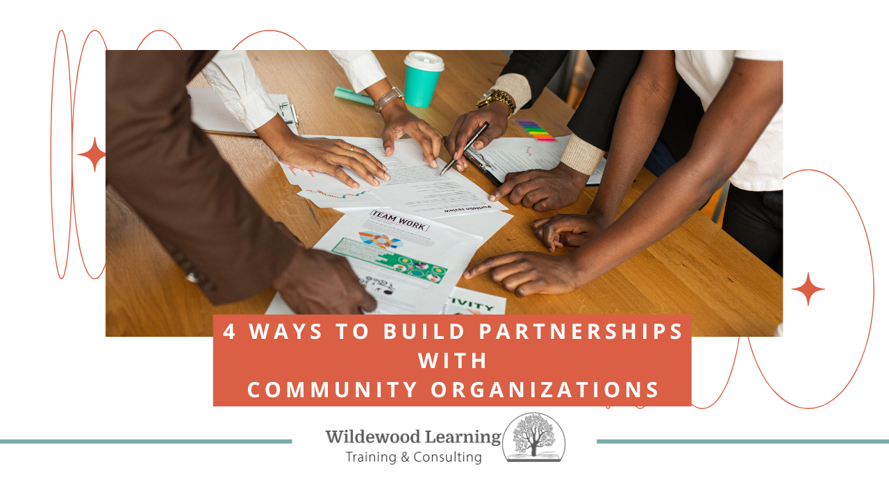 Five people collaborate around a table covered with documents, notes, and a coffee cup. Text overlay reads 4 Ways to Build Partnerships with Community Organizations. Wildewood Learning logo is at the bottom.